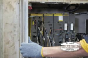 electrician replacing a breaker