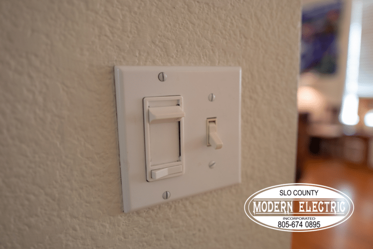 Light switch on textured wall near logo.