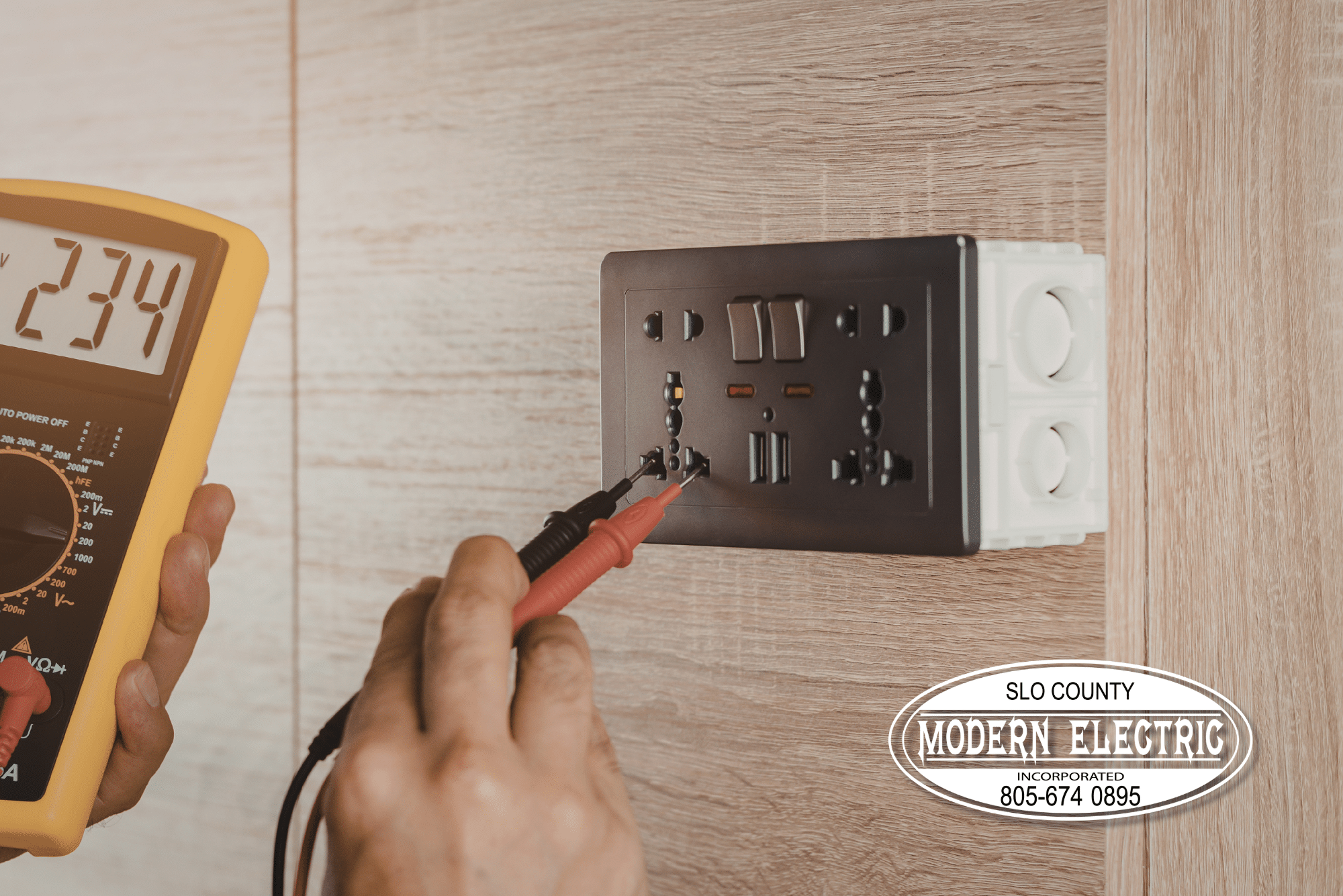 Electrician testing wall socket for voltage