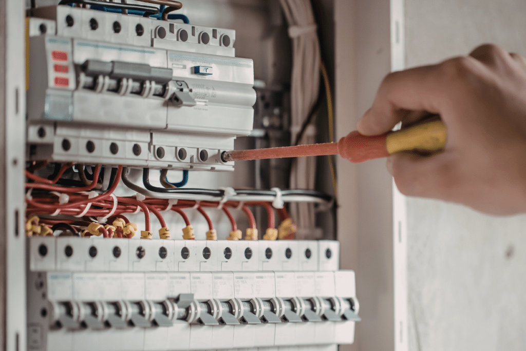 Electrician working on circuit breaker panel