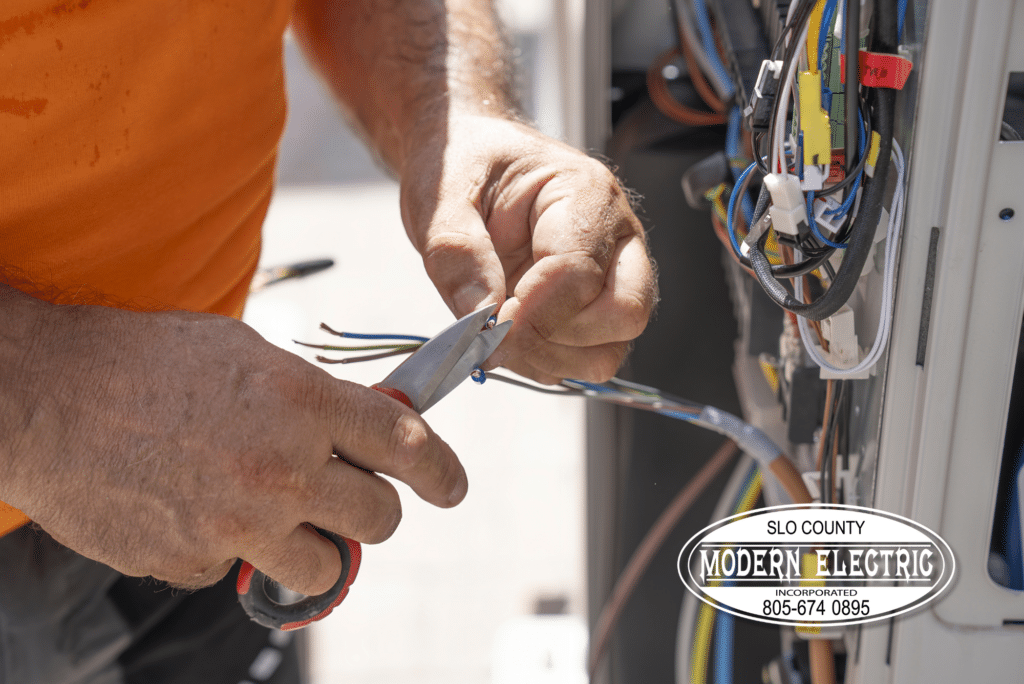 Electrician wiring a circuit panel outdoors